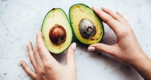 person holding sliced avocado